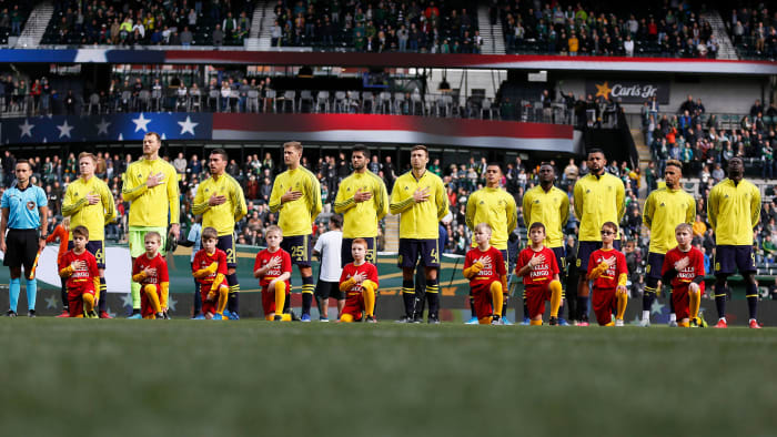 Nashville SC stands for the national anthem at an MLS game